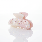 Pink and white hair clip with floral design on a white background


