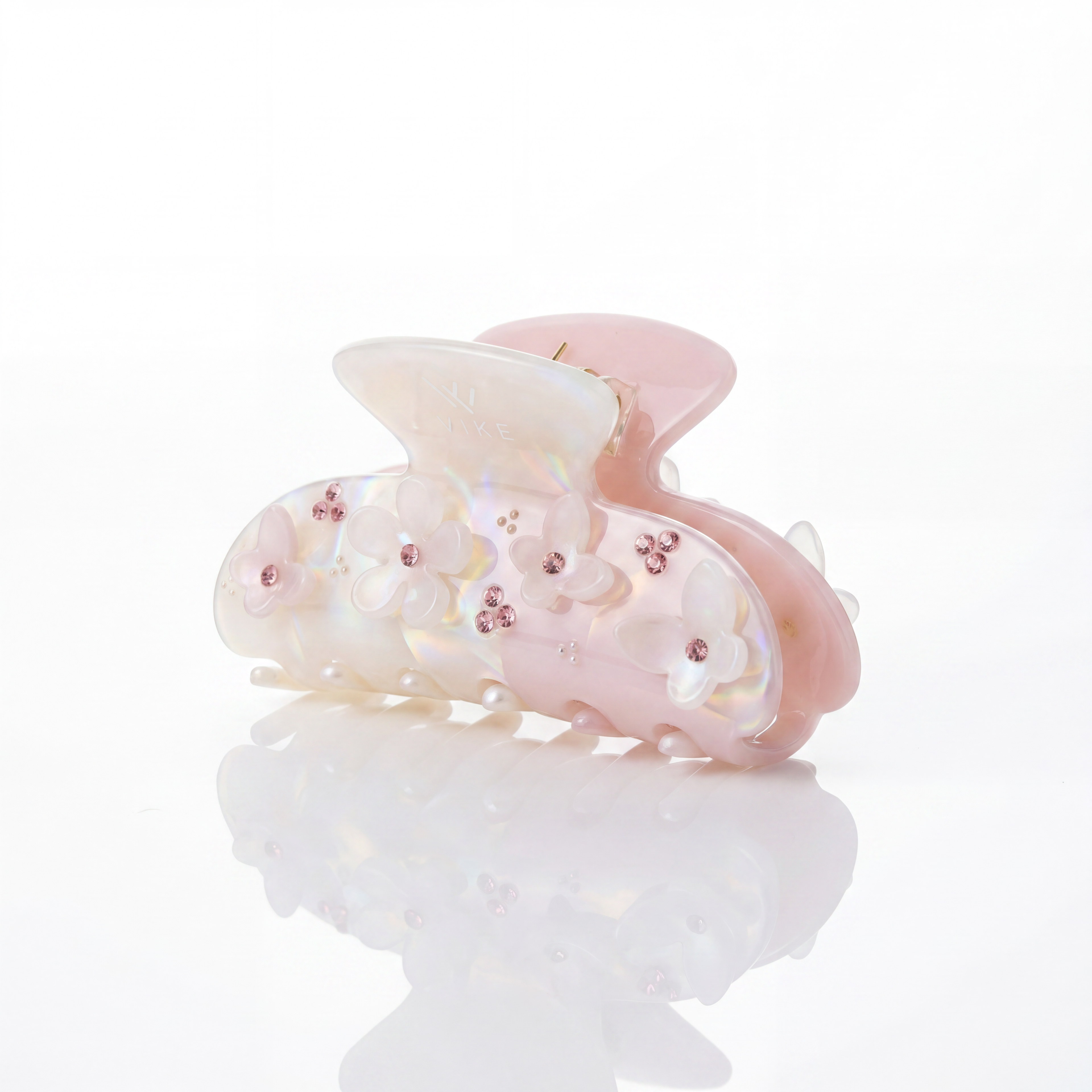 Pink and white hair clip with floral design on a white background

