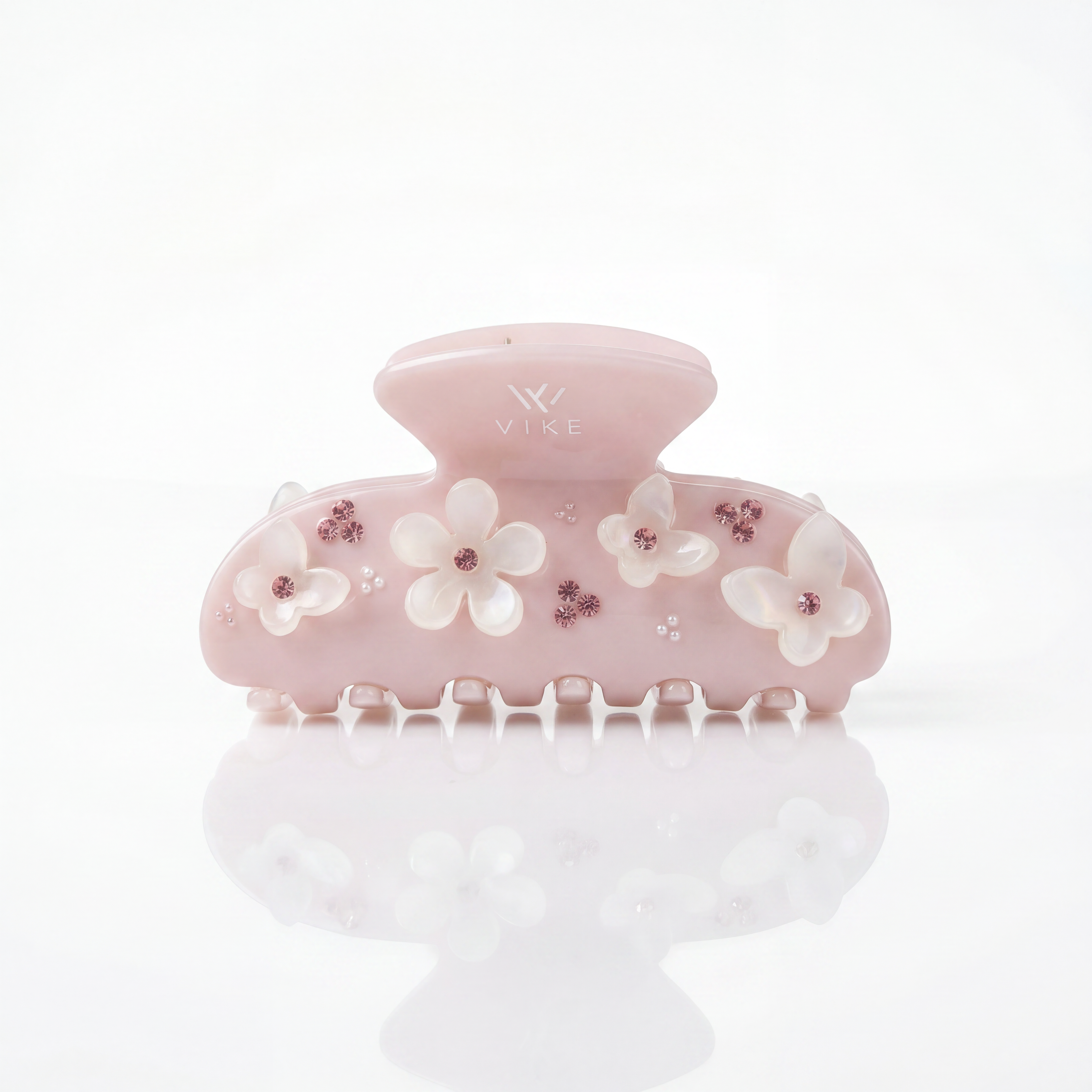 Decorative hair clip with floral designs on a white background

