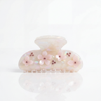 Decorative hair clip with floral designs on a white background

